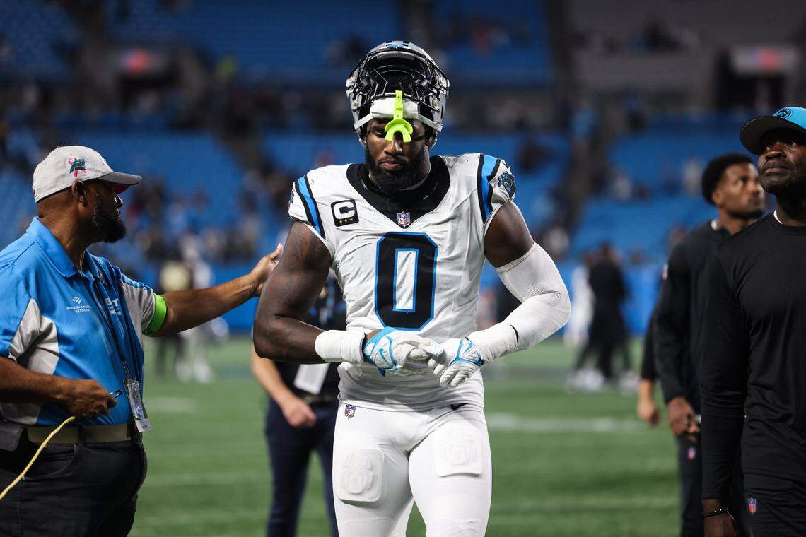 Carolina Panthers linebacker Brian Burns takes off his gloves at the end of the game against the New Orleans Saints at the Bank of America Stadium in Charlotte, N.C., on Monday, September 18, 2023.