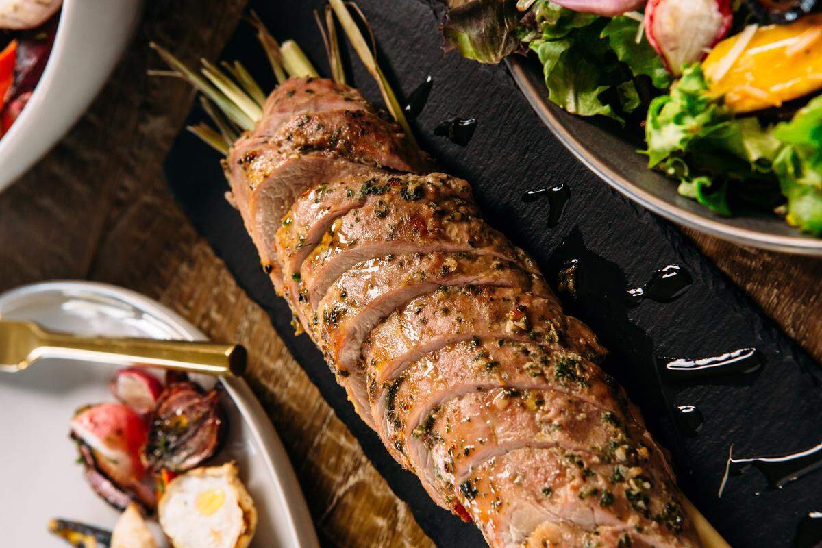 Craig Barbour serves roasted carved pork tenderloin with lemongrass and local honey at Thanksgiving.