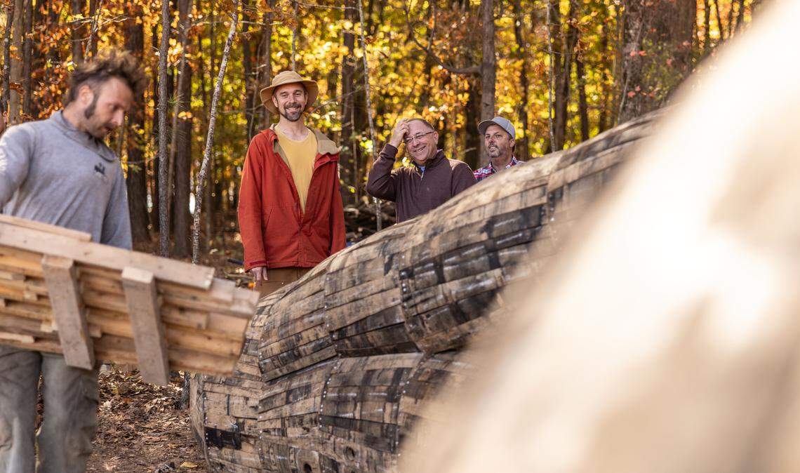Danish artist Thomas Dambo watches volunteers work on constructing his giant troll sculpture named Pete with the Big Feet in Charlotte, N.C., on Thursday, November 6, 2025.