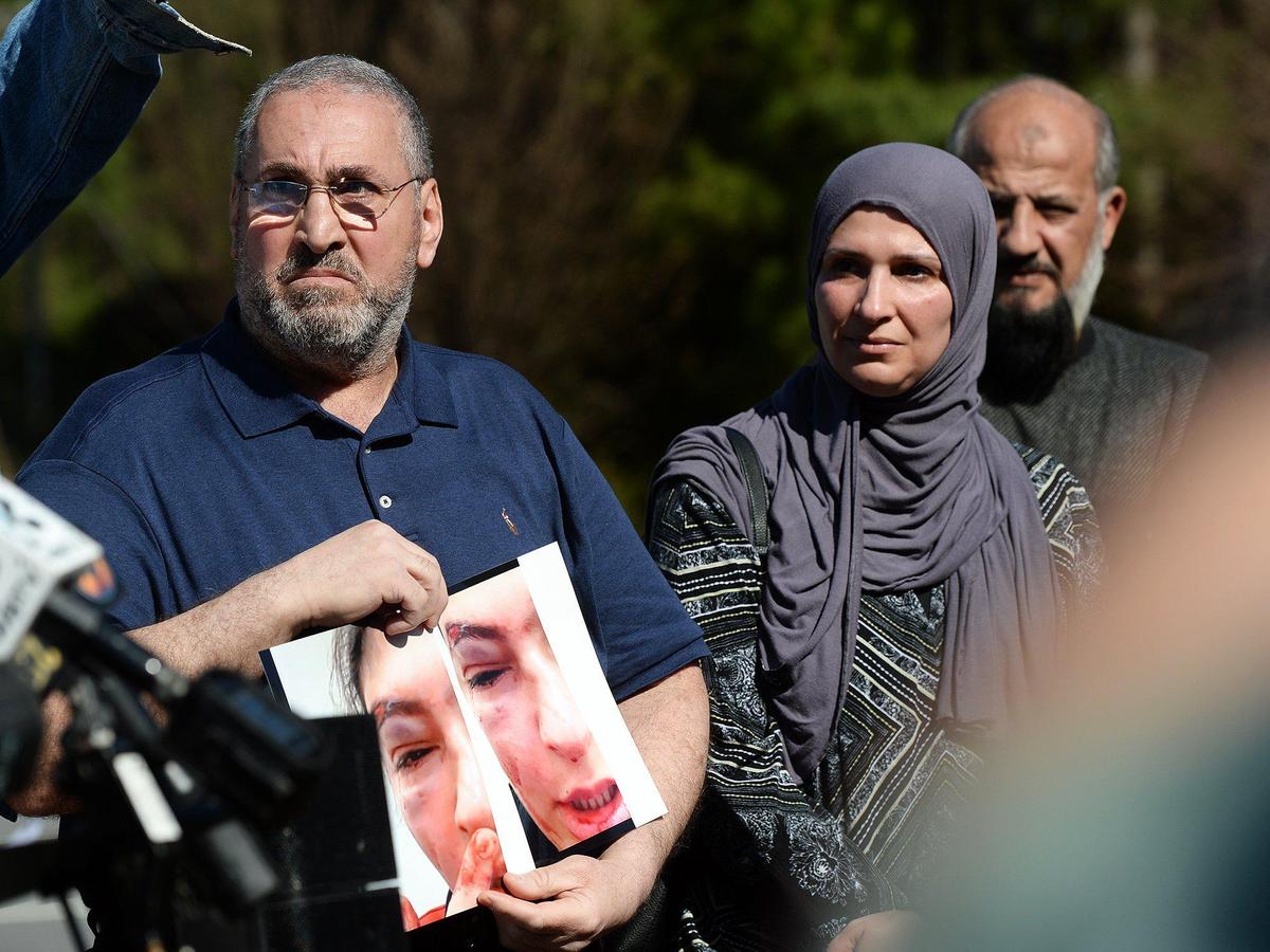 The Jasim family, parents of a female Muslim student at Ardrey Kell High School are calling for a hate crime investigation after their daughter was attacked in math class, receiving multiple broken bones to her face. The injuries are severe enough to require surgery. The victims father and mother (left and right) held photos of their daughter’s injuries. The alleged male attacker, reportedly a member of the school’s football team, became angry after the female student refused to respond to his taunts about her wearing a hijab. It is said he then called her the N word and the B word before striking her multiple times and telling her “to go back to your country”. He was suspended for 10 days. Jibril Hough, of the Islamic Center of Charlotte, represented the family, who were in attendance, at a roadside press conference across the street from Ardrey Kell High School on Wednesday, Mar. 12, 2025.