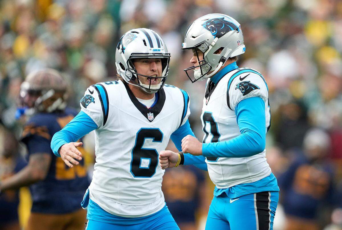 Ryan Fitzgerald of the Carolina Panthers (right) celebrates with teammates after kicking the 49-yard, game-winning field goal during the fourth quarter in the game at Lambeau Field Sunday.