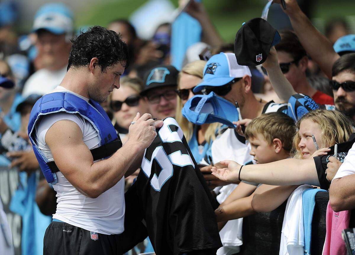 Carolina Panthers middle linebacker Luke Kuechly (59) signs autographs for fans at the end of training camp at Wofford College in Spartanburg, SC on Sunday, August 13, 2017.