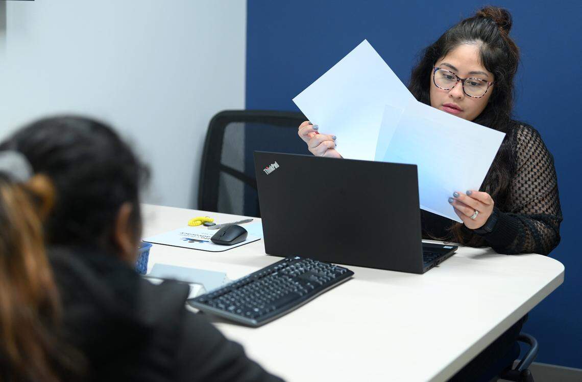 Charlotte Center for Legal Advocacy supervising attorney Kiara Vega, right, looks over paperwork for Erika Salamanca, left, at the Charlotte Center for Legal Advocacy on Friday, November 11, 2022. Charlotte Center for Legal Advocacy was holding a pro-se asylum clinic to help an increasing number of pre-selected asylum seekers.