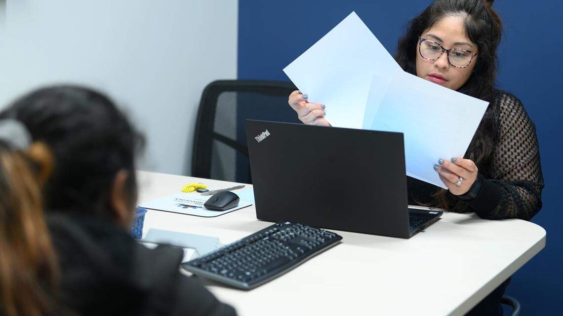 Charlotte Center for Legal Advocacy supervising attorney Kiara Vega, right, looks over paperwork for Erika Salamanca, left, at the center’s office on Nov. 11, 2022.