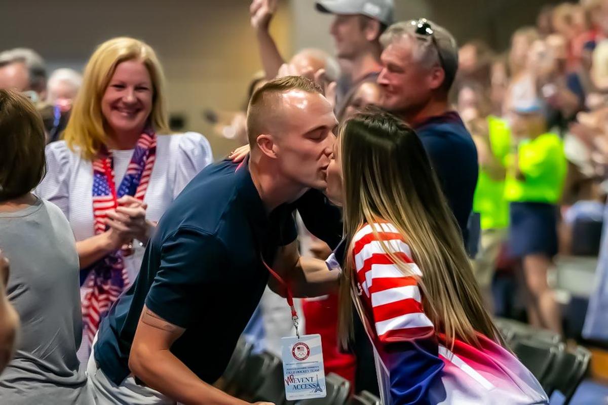Amanda Golini gives her husband a smooch at the Providence Day Pep rally for the USA Field Hockey sendoff to the Olympics in Paris