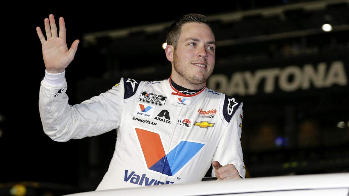 FILE - In this Feb. 13, 2020, file photo, Alex Bowman waves to fans during driver introductions before the first of two Daytona 500 qualifying auto races at Daytona International Speedway in Daytona Beach, Fla. Bowman scored his first iRacing victory of NASCAR’s invitational series by holding off Corey LaJoie and Ryan Preece in a two-lap overtime sprint to the finish at virtual Talladega Superspeedway. (AP Photo/Terry Renna, File)