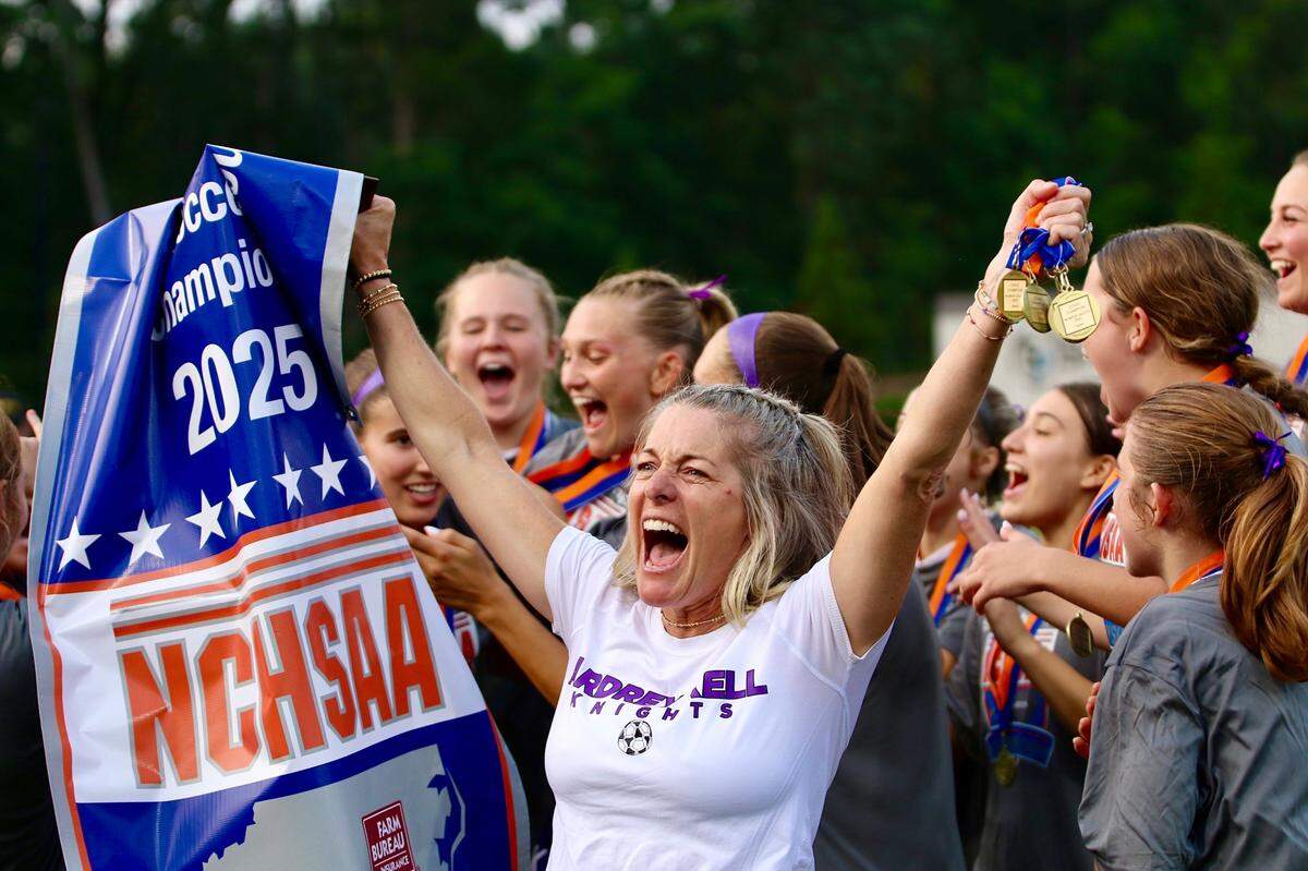 Ardrey Kell girls’ soccer coach Kim Montgomery celebrates after her team won its second NCHSAA 4A state title in May 2025 at the Matthews Sportsplex.