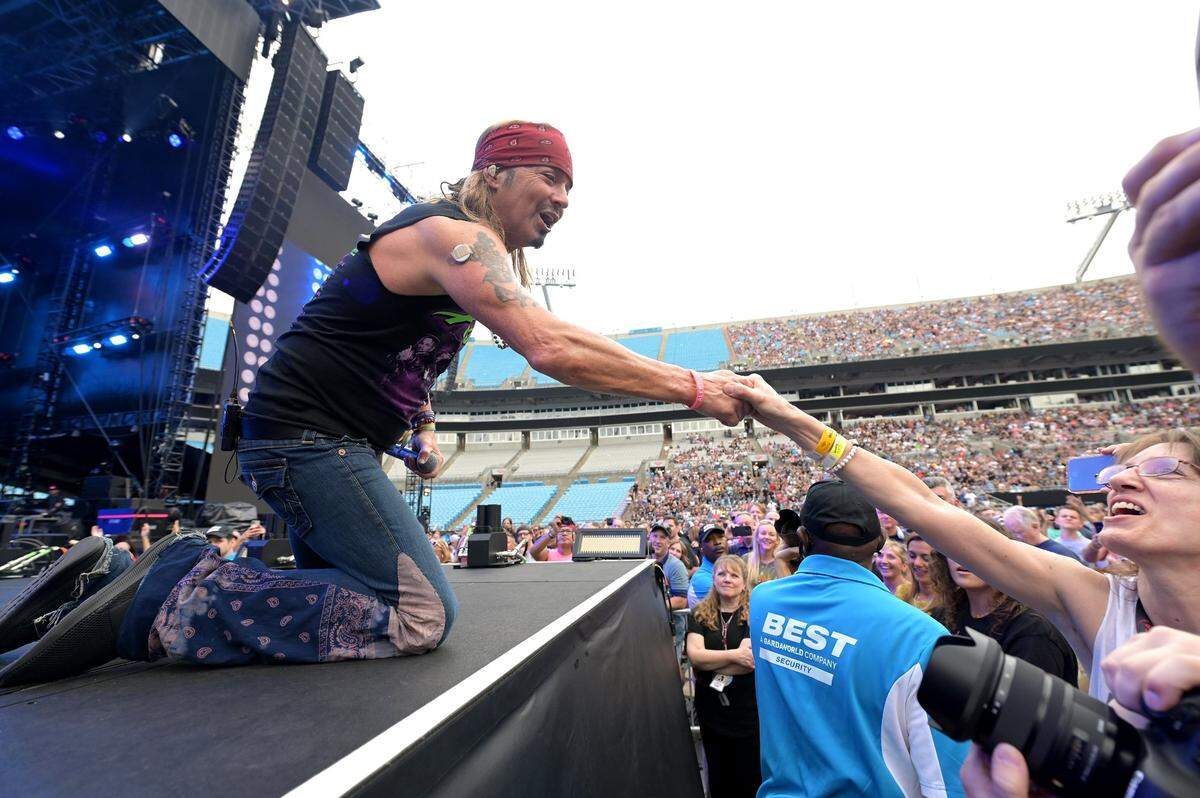 Poison lead singer Bret Michaels reaches out to shake hands with a fan during the band’s performance at The Stadium Tour 2022 at Bank of America Stadium in Charlotte, June 28, 202. The concert featured Classless Act, Joan Jett and The Blackhearts, Motley Crue and Def Leppard.