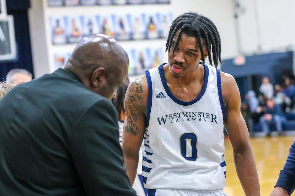 Westminster Catawba’s Tim Hall (center) chats with head coach Ed Addie
