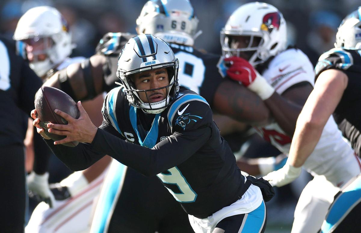 Carolina Panthers quarterback Bryce Young scrambles out of the pocket during action against the Arizona Cardinals at Bank of America Stadium in Charlotte, NC on Sunday, December 22, 2024.