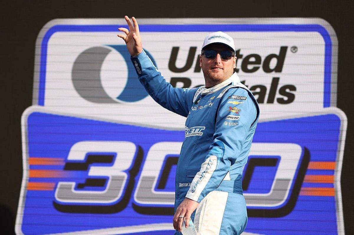 Austin Hill, driver of the #21 Bennett Transportation Chevrolet, waves to fans as he walks onstage during driver intros prior to the NASCAR O'Reilly Auto Parts Series United Rentals 300 at Daytona International Speedway on February 14, 2026 in Daytona Beach, Florida.