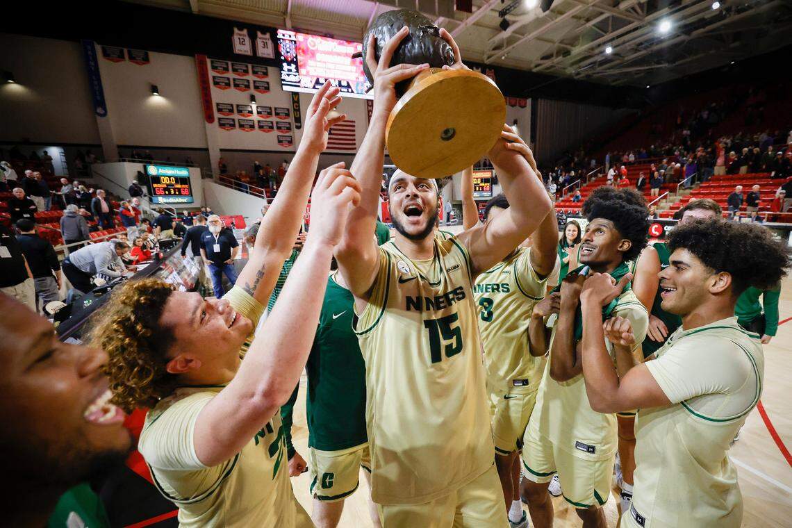 Charlotte 49ers forward Aly Khalifa (15) celebrates with the Hornets Nest trophy after a game against the Davidson Wildcats at Belk Arena in Davidson, N.C., Tuesday, Nov. 29, 2022.