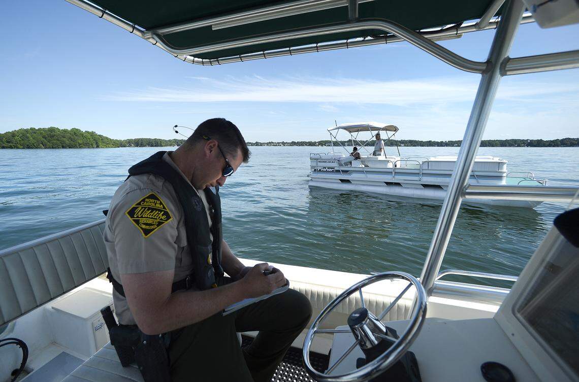 In this 2018 file photo, Sampson Parker Jr., an officer for the N.C. Wildlife Resources Commission, checks for Lake Norman boaters’ registration and safety equipment.  A drunken boater at the coast recently became the first person to be convicted under a tougher-penalty law prompted by a teenager’s death on Lake Norman.