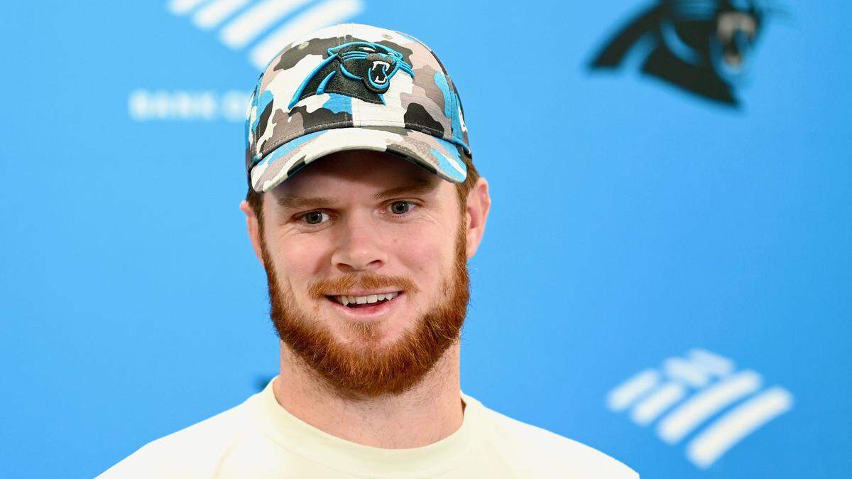 Carolina Panthers quarterback Sam Darnold smiles as he talks how his relationship with former Carolina Panthers running back Christian McCaffrey on Friday, October 21, 2022. McCaffrey was traded late Thursday night to the San Francisco 49ers for future draft picks. Jeff Siner/The Charlotte Observer