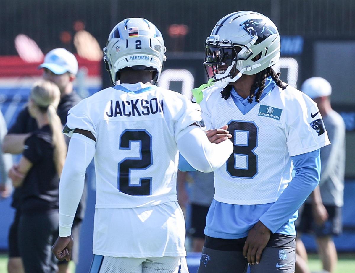 Panthers defensive back Mike Jackson, left, and cornerback Jaycee Horn slap hands after running drills together during training camp in Charlotte, NC on Wednesday, July 24, 2025.