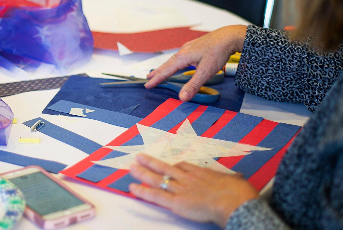 Laura Meier works on her story at an “Airing Out the ‘Dirty’ Laundry” workshop at the Levine Museum of the New South in February. Charlotte artist Andrea Downs holds the visual arts workshops throughout Charlotte.