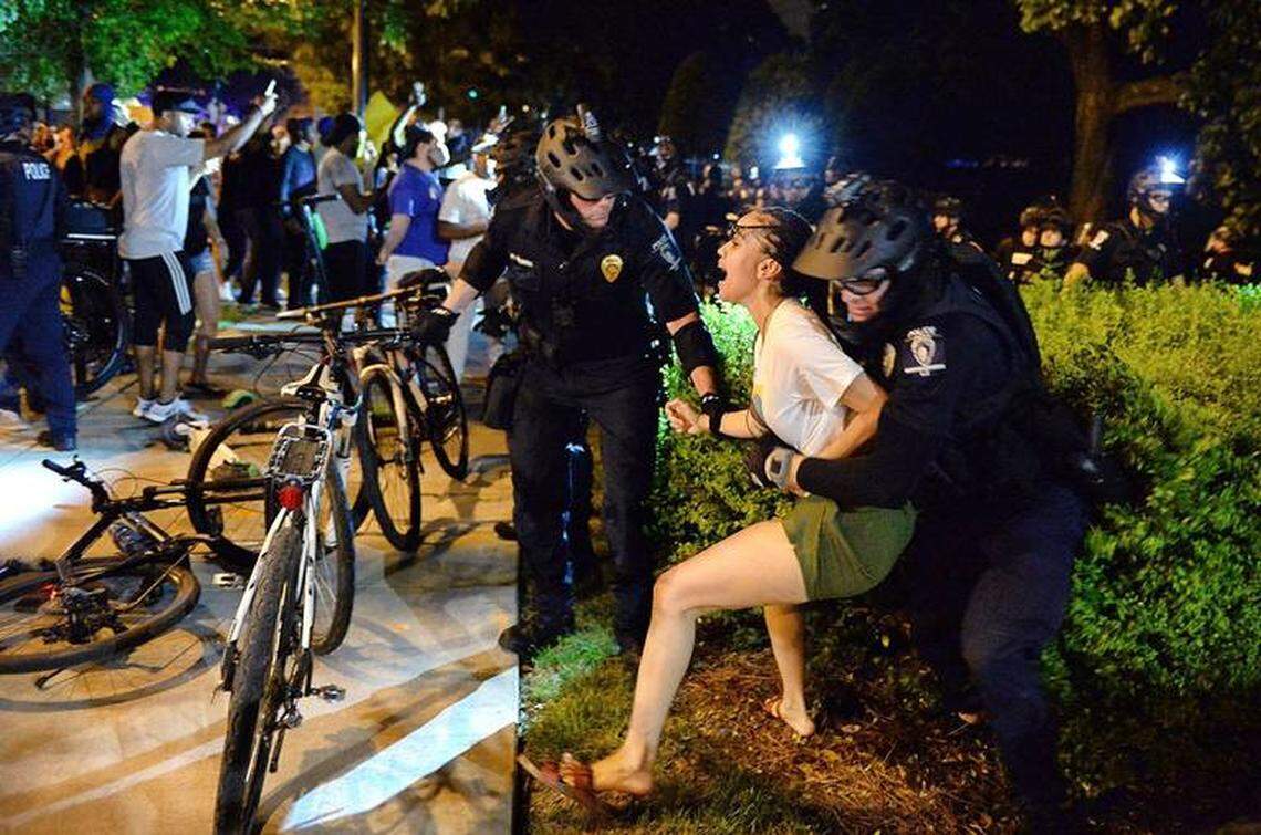 CMPD officers arrest a female protester along E. Trade Street in Charlotte, NC on Saturday, May 30, 2020. The protesters are protesting the death of George Floyd in Minneapolis, MN on Monday, May 25, 2020.