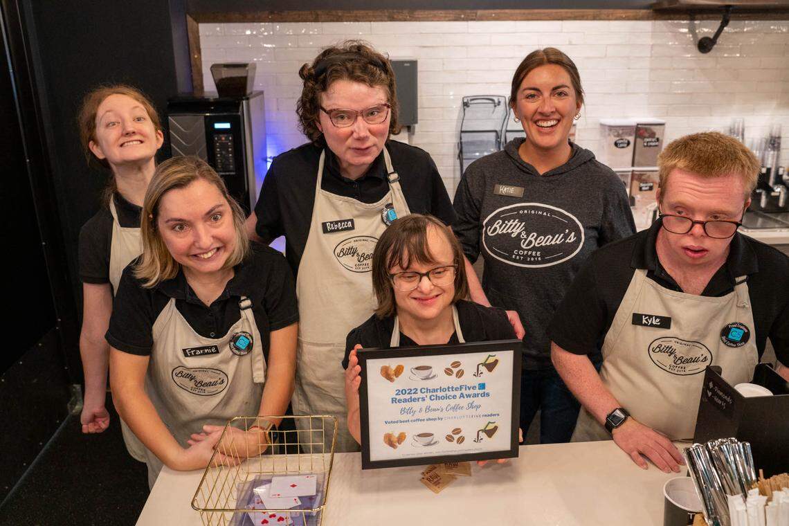 The staff of Bitty & Beau’s Coffee in Charlotte holds a plaque for the best coffee shop in the Charlotte area, according to the CharlotteFive Readers’ Choice awards.
