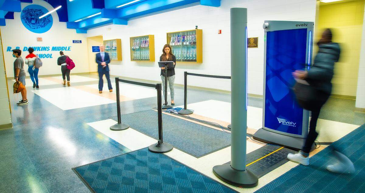 A students walks through the body scanner at R.P. Dawkins Middle School in Spartanburg, S.C. CMS officials consulted the Spartanburg district before implementing their own scanners.
