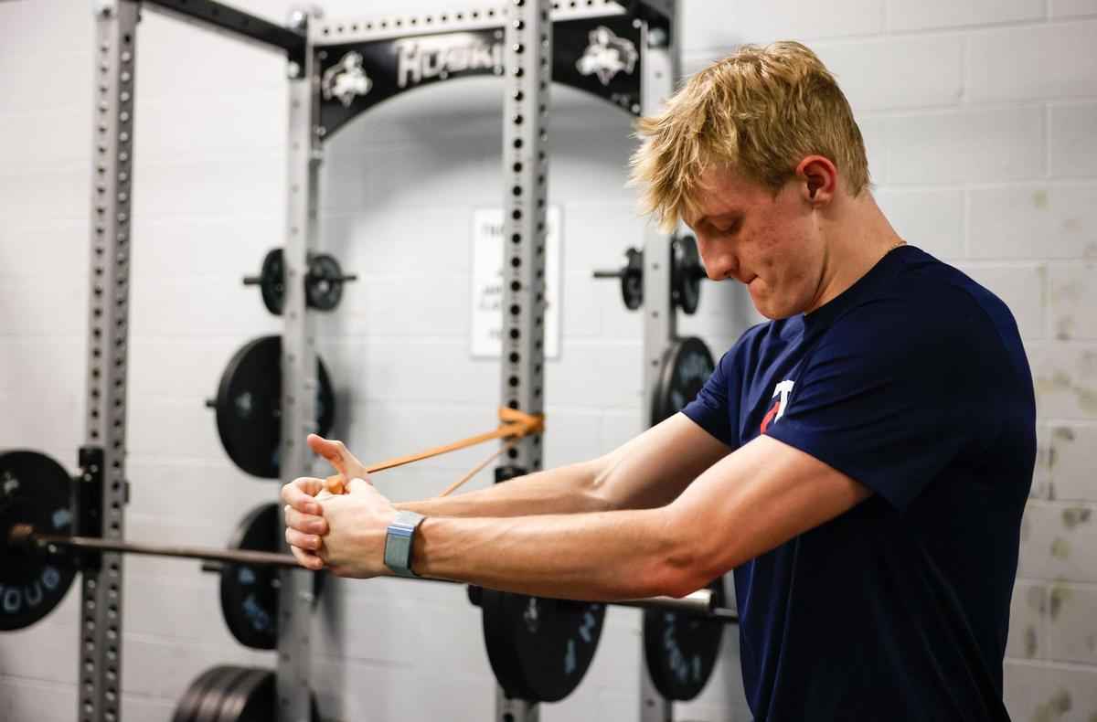 Tyler Baird, a baseball player at Hough High School, works out in the weightroom on Wednesday, February 12, 2025. Baird is one of the best players in the state and a major college recruit.