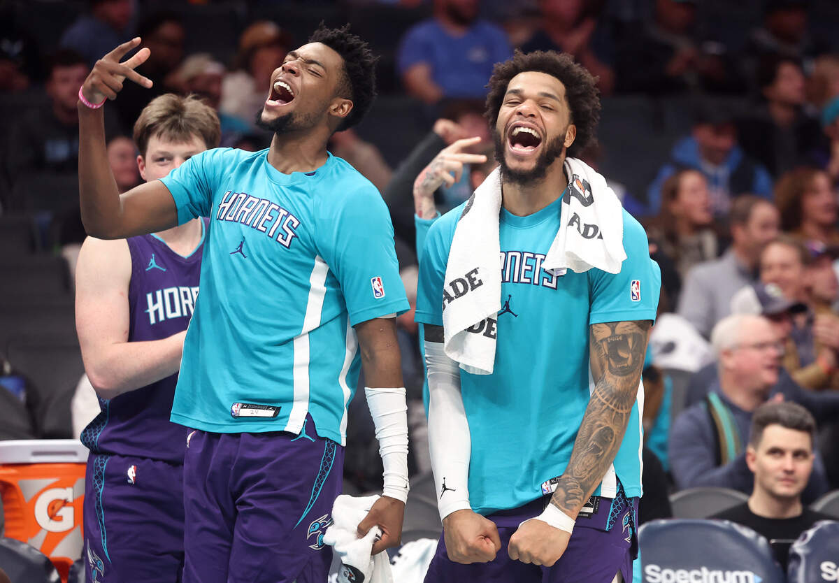 Charlotte Hornets guard Brandon Miller, left and forward Miles Bridges, right, celebrate the team’s play during action against the Philadelphia 76ers at Spectrum Center in Charlotte, NC on Monday, January 26, 2026. The Hornets defeated the 76ers 130-93.