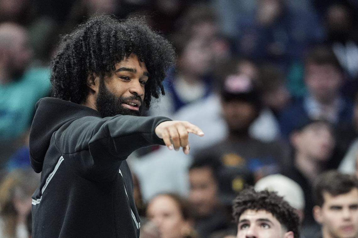 Charlotte Hornets guard Coby White points during the first half of an NBA basketball game against the Dallas Mavericks, Tuesday, March 3, 2026, in Charlotte, N.C. 