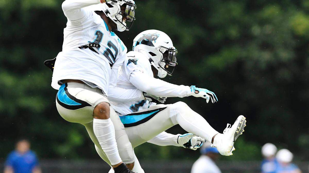 Carolina Panthers wide receiver D.J. Moore (12) jumps and celebrates wide receiver Curtis Samuel (10) long touchdown catch against the Buffalo Bills during their joint practice at Wofford College in Spartanburg, SC on Wednesday, August 14, 2019.