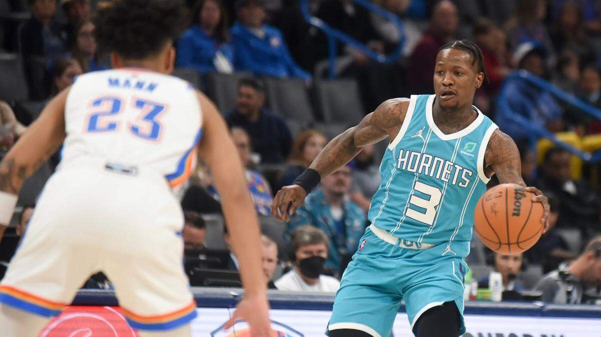 Charolette Hornets guard Terry Rozier (3) looks for an opening past Oklahom City Thunder guard Tre Mann (23) in the first half of an NBA basketball game, Monday, March 14, 2022, in Oklahoma City. (AP Photo/Kyle Phillips)