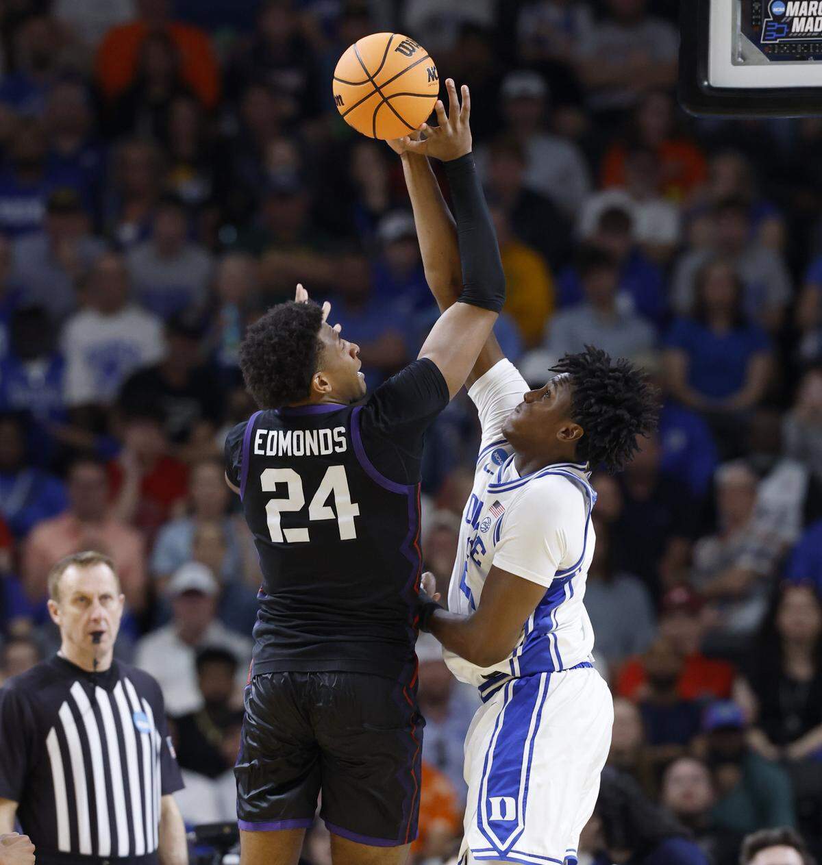 Duke’s Patrick Ngongba II (21) blocks the shot by TCU’s Xavier Edmonds (24) during the second half of Duke’s 81-58 victory over TCU in the second round of the NCAA Tournament Saturday.
