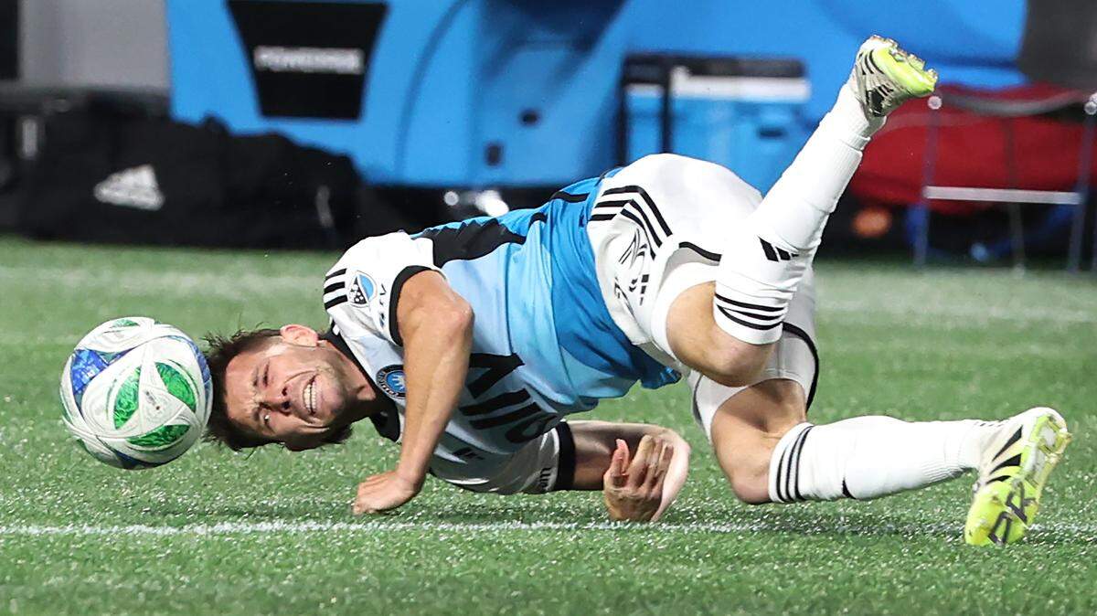 Charlotte FC central midfielder Brandt Bronico watches the ball skip away on the turf of the pitch after being tripped during action against the New York City FC on Tuesday, October 28, 2025.