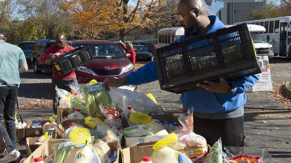 Andreas Kersey, with the YMCA, added items to complete the Thanksgiving Day Meal Day meals that were distributed by Loaves & Fishes Friendship Trays to families on Friday, Nov. 19, 2021 at the Johnston YMCA