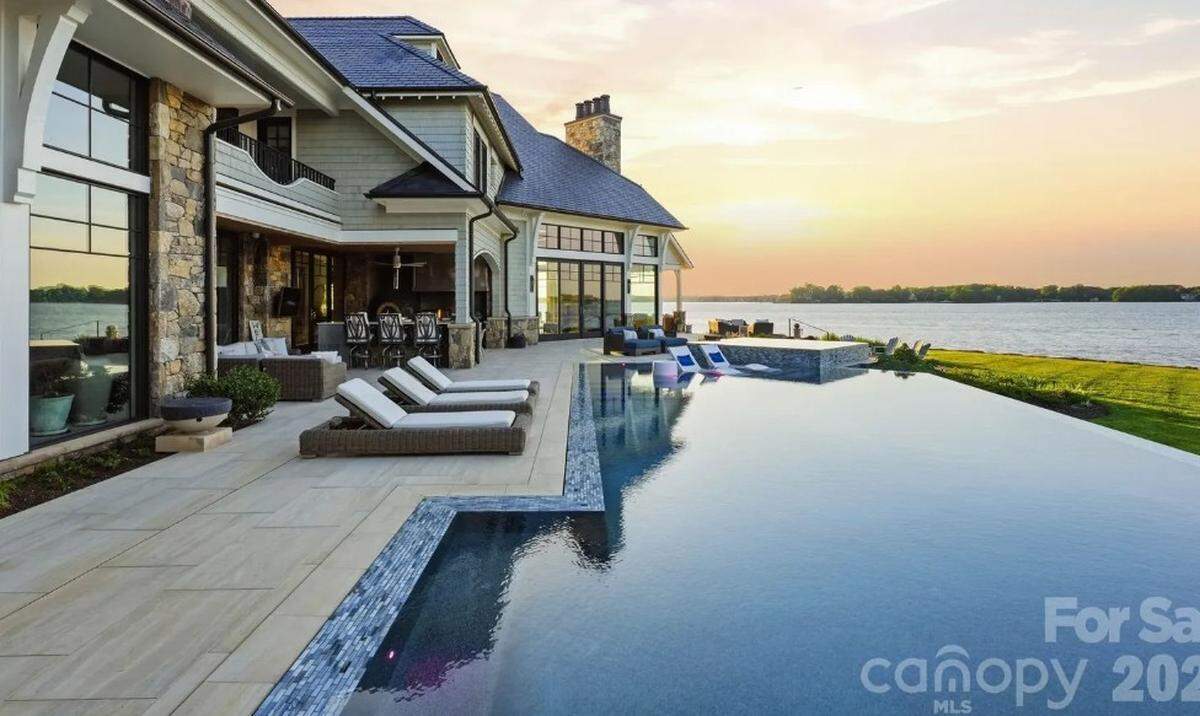 The mansion includes an infinity-edge pool and spa overlooking the lake.