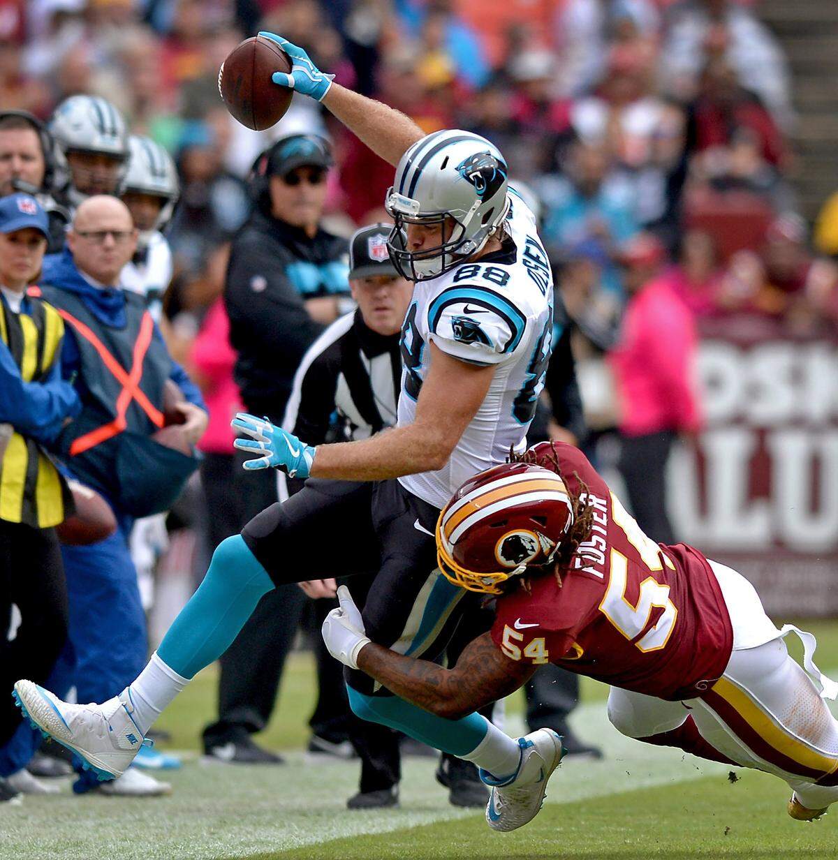 Carolina Panthers tight end Greg Olsen, left, fights for yardage on Sunday, October 14, 2018. Washington defeated the Panthers 23-17. It was Olsen’s first game back after re-fracturing his foot in Week 1.