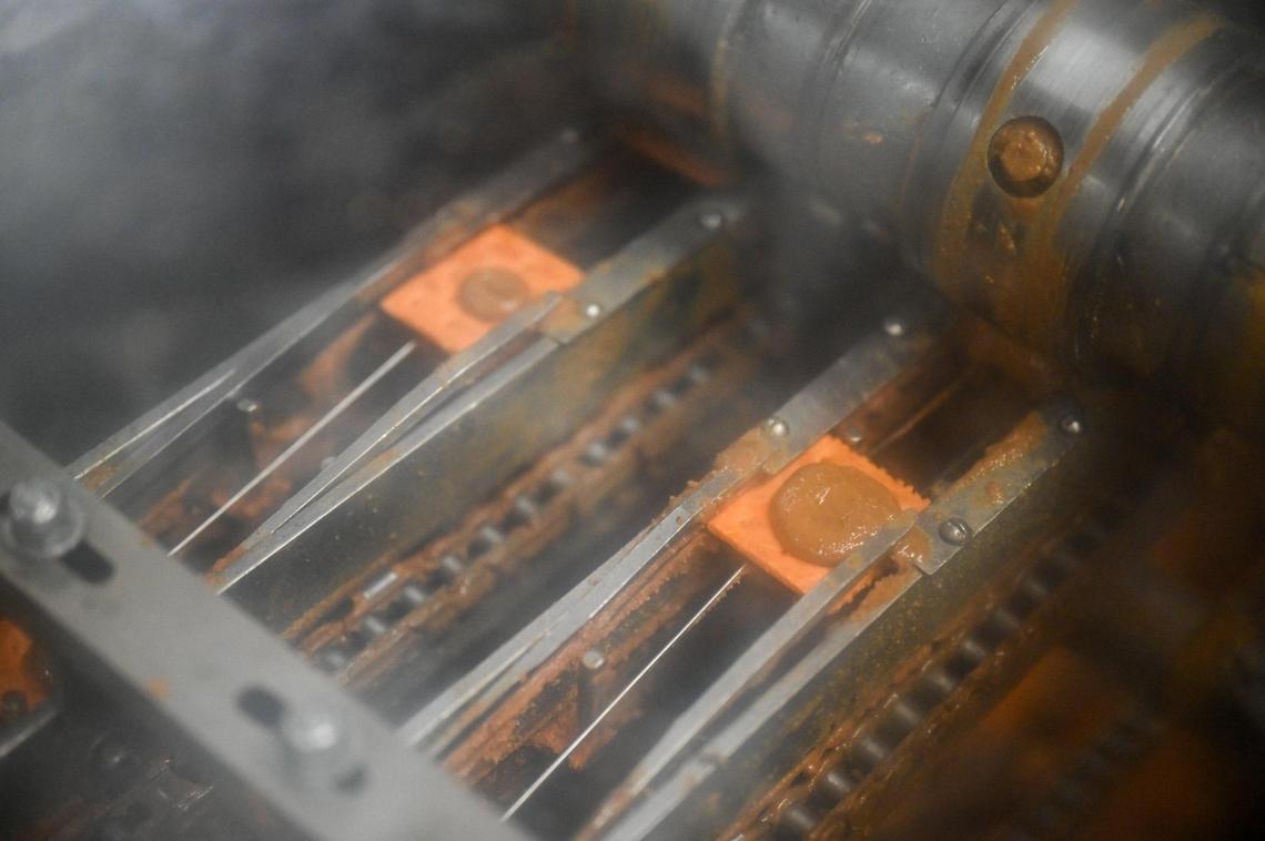 Peanut butter, which is made in-house, is placed on cheese crackers to make Lance Toast Chee cracker sandwiches Nov. 8, 2023, at Campbell’s Snacks plant in Charlotte, N.C.