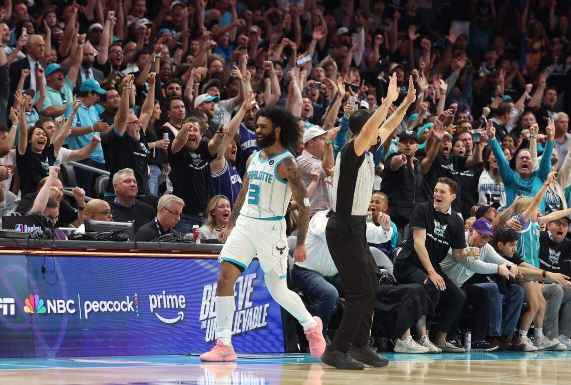 Charlotte Hornets guard Coby White and the fans celebrate his three-point basket against the Miami Heat during action at Spectrum Center in Charlotte, NC on Tuesday, April 14, 2026. The Hornets defeated the Heat 127-126 in NBA Play-in-Tournament basketball game.