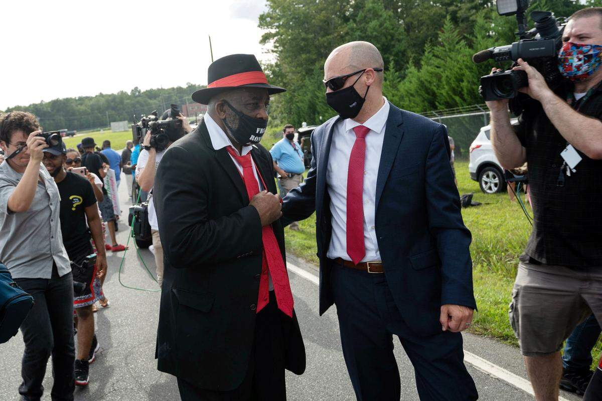 After 44 years fighting his conviction, Ronnie Long walks with his attorney Jamie Lau after being released from prison at Albemarle Correctional Institute on Aug. 27, 2020.