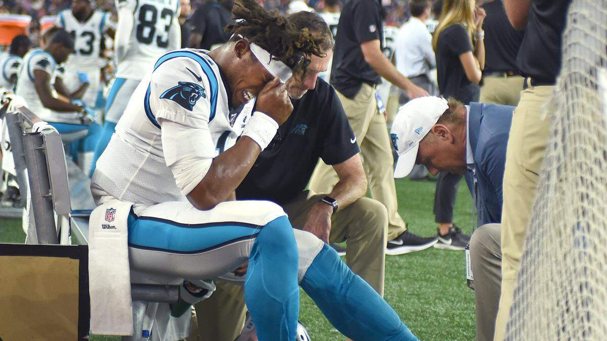 Panthers quarterback Cam Newton grimaces in pain after injuring his left foot Aug. 22 against New England in the preseason. The injury made Newton basically unable to run during the Panthers’ first two regular-season games, he said in a video blog posted Friday. But Newton also said he hid the full severity of the injury from his coaches so he could play.