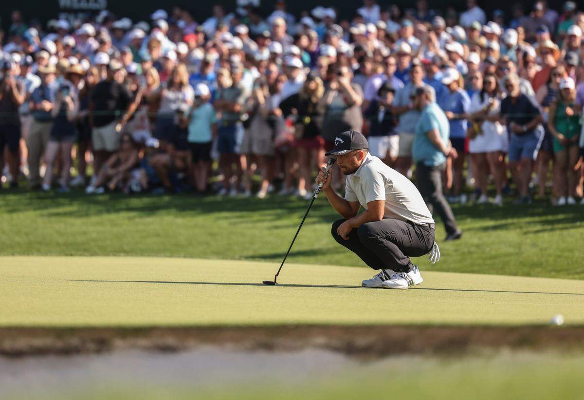 Xander Schauffele lines up his putt on the 18th hole during round three of the Wells Fargo Championship at Quail Hollow Club in Charlotte, N.C., on Saturday, May 11, 2024.