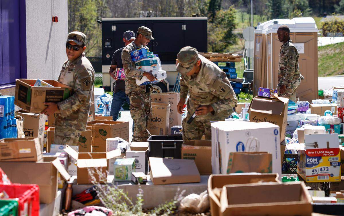 Soldiers work Wednesday, Oct. 9, 2024, at the Mitchell Elementary/Middle School donation supply distribution center in Bakersville. About 1,300 soldiers from Fort Liberty in Fayetteville, Fort Campbell in Kentucky and Fort Meade in Maryland have been mobilized to help with Hurricane Helene relief.