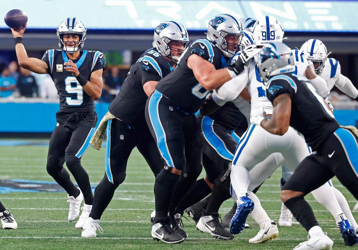Carolina Panthers quarterback Bryce Young, left, looks to pass up the middle as the Indianapolis Colts defense rushes during second-quarter action on Sunday, November 5, 2023 at Bank of America Stadium in Charlotte, NC.