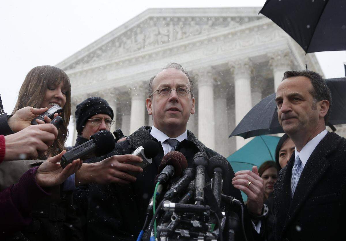 Paul Clement, center, attorney for Hobby Lobby and Conestoga Wood, center, speaks to reporters in 2014 after the Supreme Court heard oral arguments in the challenges of President Obama's health care requirement that businesses provide female employees with insurance that includes access to contraceptives. Clement is now representing defunct Charlotte School of Law in its new lawsuit against the American Bar Association of the school's loss of accreditation in 2016.