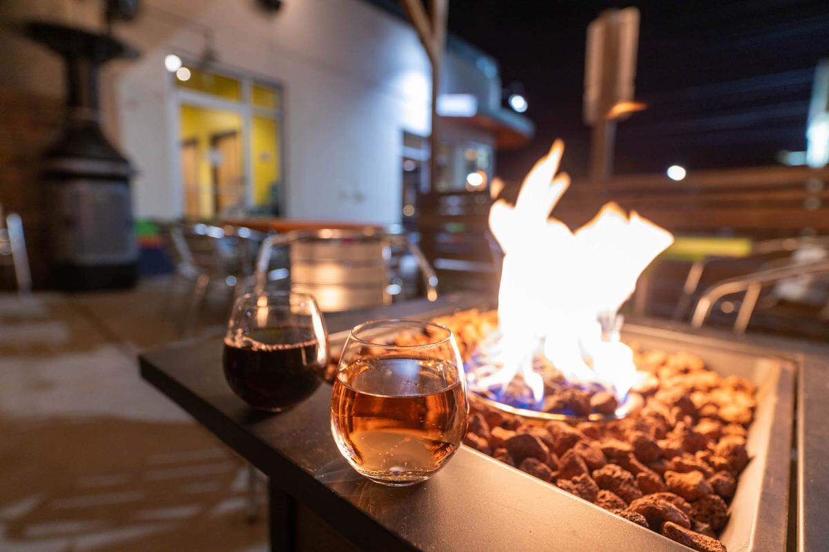 Grab a glass of wine at Toucan Louie’s and stay warm by the fire pit.