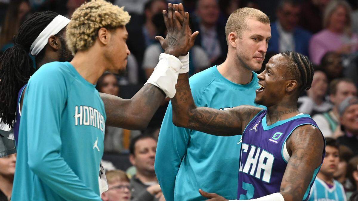 Charlotte Hornets guard Terry Rozier, right, is congratulated by his teammates after scoring a three-pointer during second half action against the Washington Wizards at Spectrum Center in Charlotte, NC on Sunday, April 10, 2022. Rozier scored 25 points in the game. The Hornets defeated the Wizards 124-108.