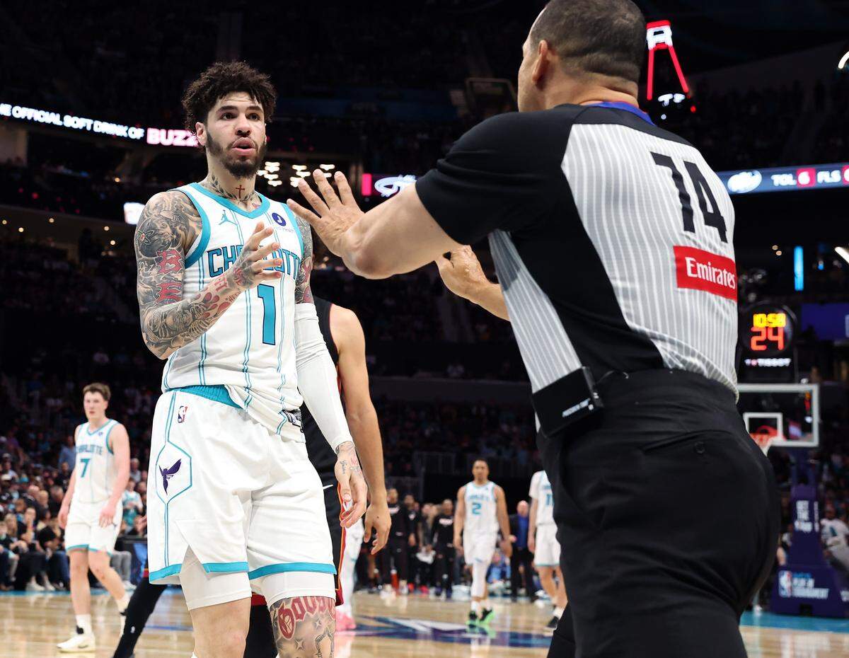 Charlotte Hornets guard LaMelo Ball, left, approaches referee Curtis Blair, right, during action at Spectrum Center in Charlotte, NC on Tuesday, April 14, 2026. The Hornets defeated the Heat 127-126 in NBA Play-in-Tournament basketball game.
