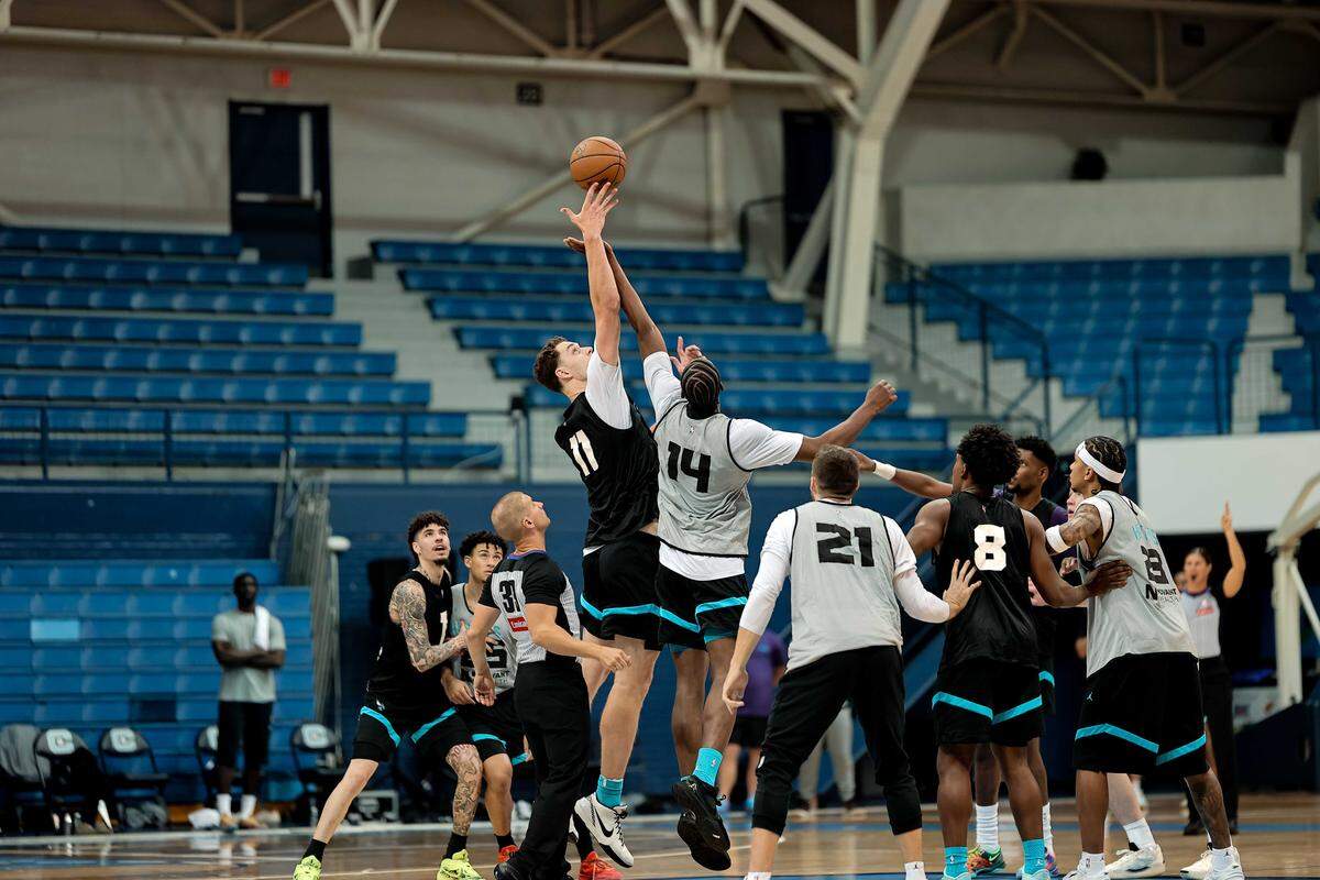 Charlotte Hornets rookie Ryan Kalkbrenner jumps up with center Moussa Diabaté during training camp practice at The Citadel.