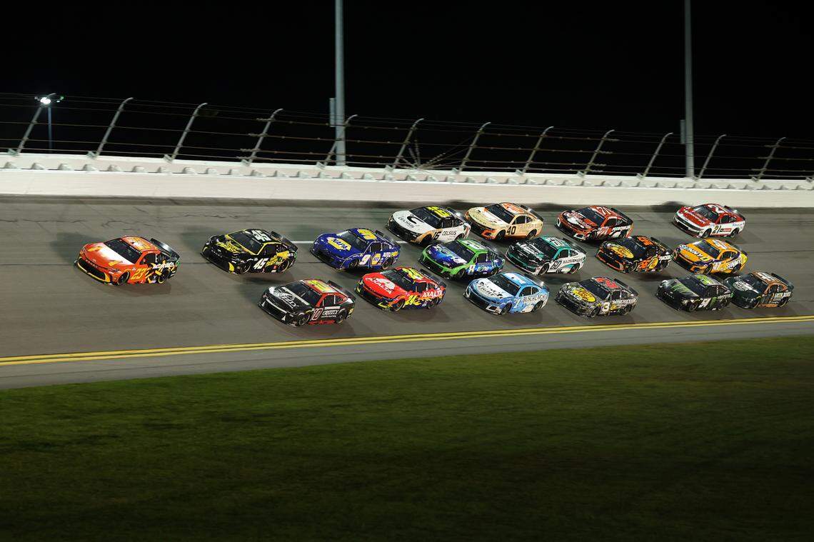 Feb 13, 2025; Daytona Beach, Florida, USA; NASCAR Cup Series driver Bubba Wallace (23) leads the field in turn four during Duel 1 at Daytona International Speedway. Mandatory Credit: Mike Watters-Imagn Images