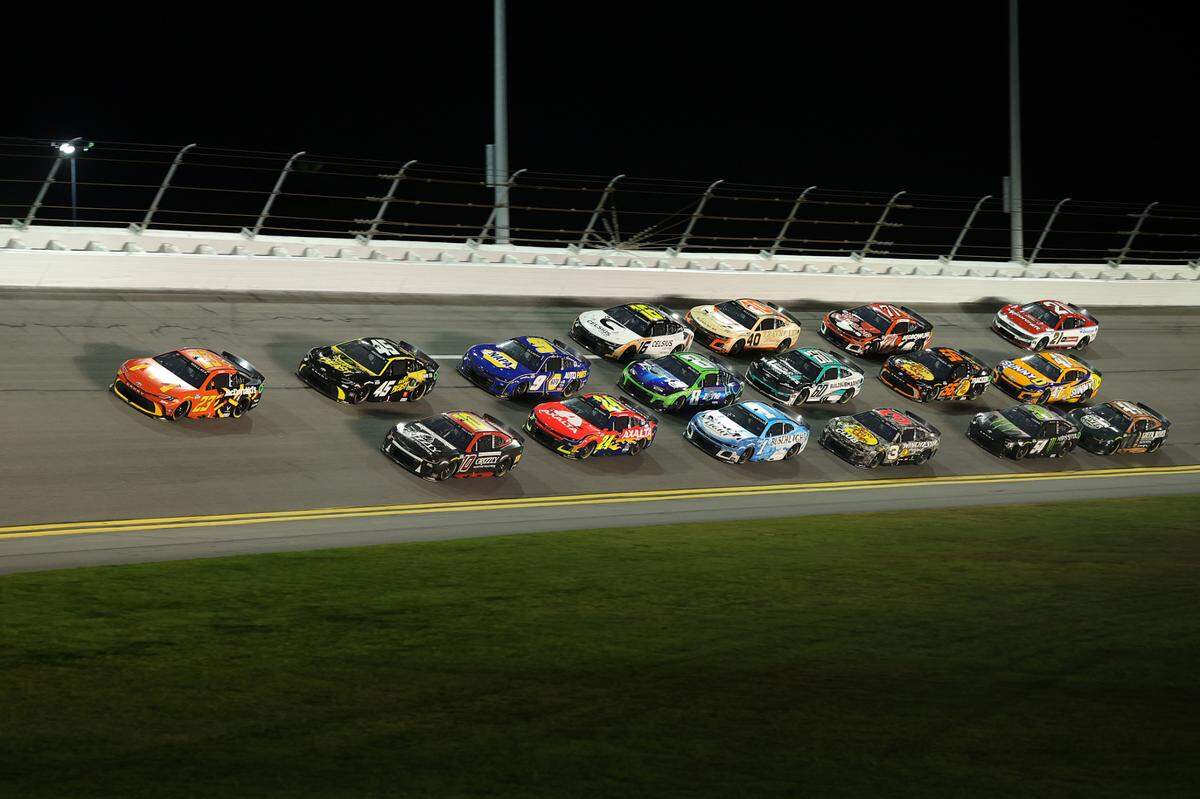 NASCAR Cup Series driver Bubba Wallace (23) leads the field in turn four during Duel 1 at Daytona International Speedway.