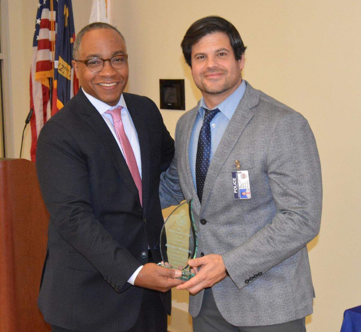 Mecklenburg District Attorney Spencer Merriweather awards Charlotte-Mecklenburg Police Department Detective Michael Melendez with The Above and Beyond Law Enforcement Award.