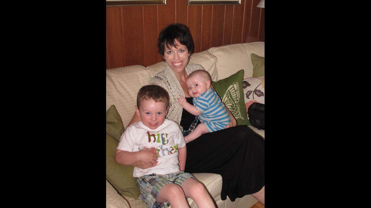 Meg McElwain in 2012 with sons Mitchell, in McElwain’s lap, and Frank, pictured left.