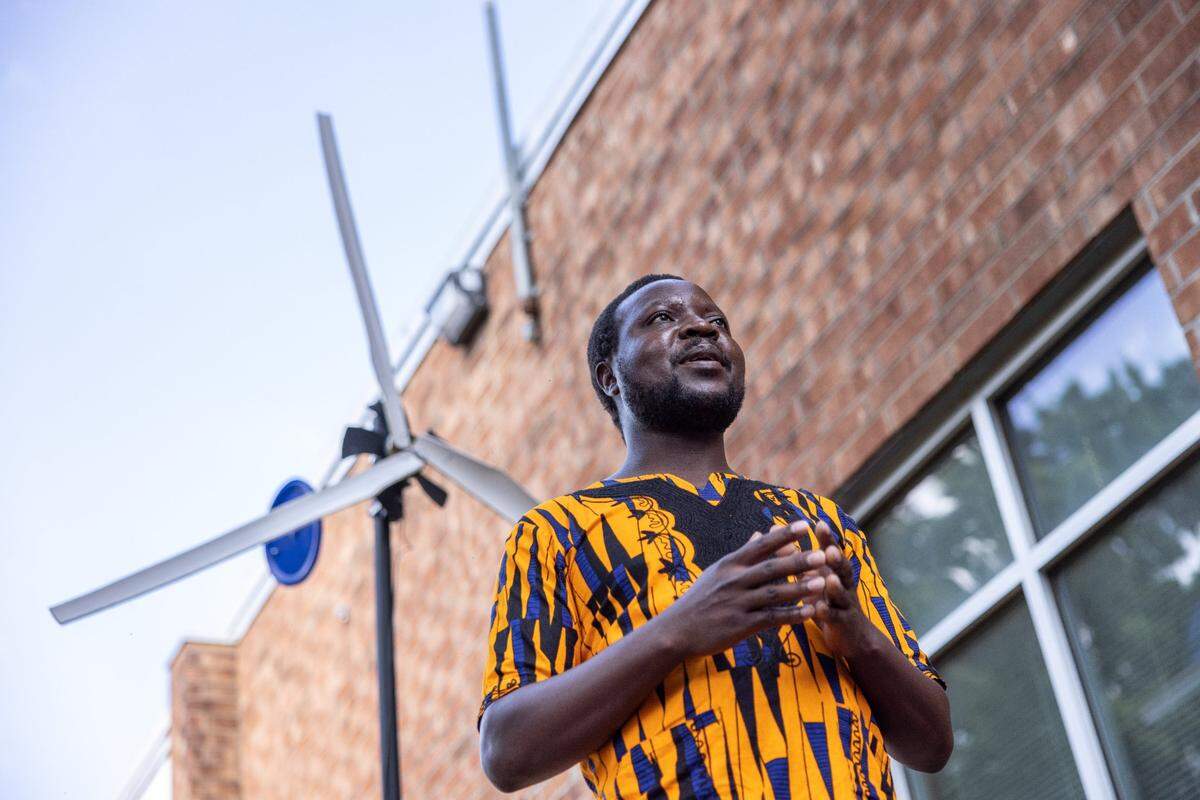 William Kamkwamba, author the children’s novel, “The Boy Who Harnessed the Wind,” speaks during a dedication ceremony for a windmill that students built at Randolph Middle School in Charlotte, June 6, 2022.